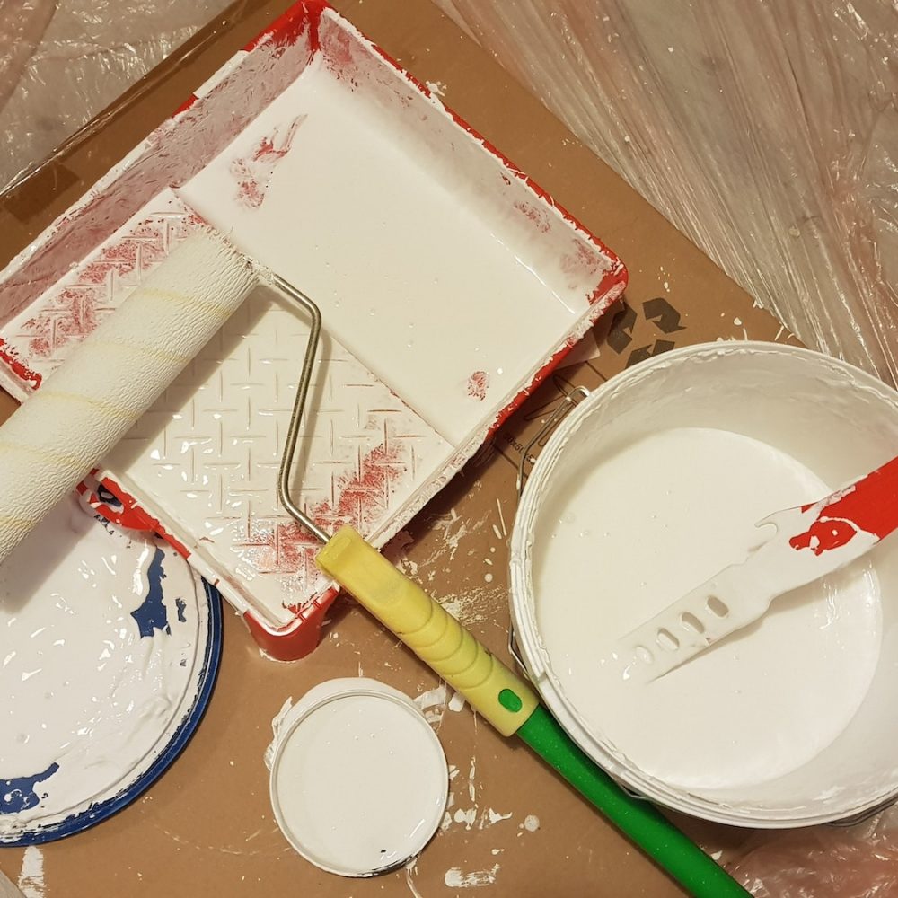 Equipment for painting walls at home with white paint.